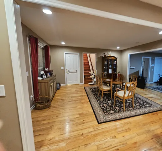 a kitchen with kitchen island granite countertop wooden floors a stove and a sink