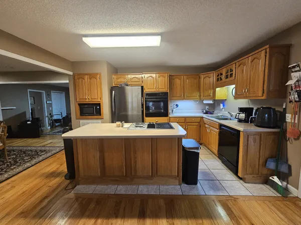 a kitchen with a stove a sink and a refrigerator