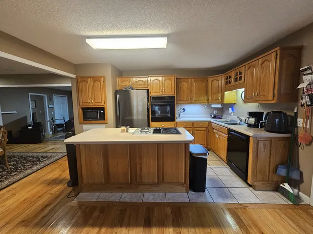 a kitchen with a stove a sink and a refrigerator