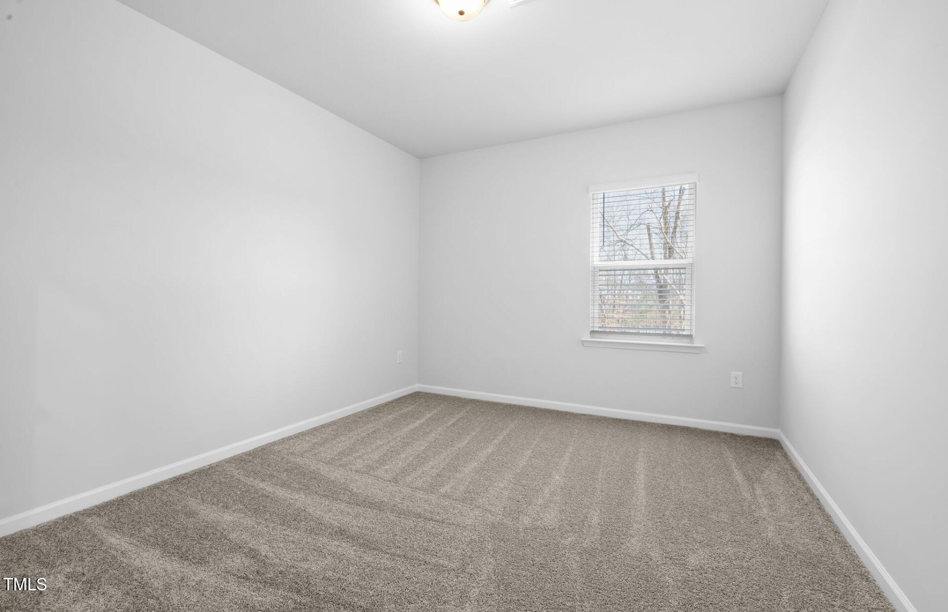 1103 Freestone Road Durham, NC 27703 - Photo 16 of 17 an empty room with a window