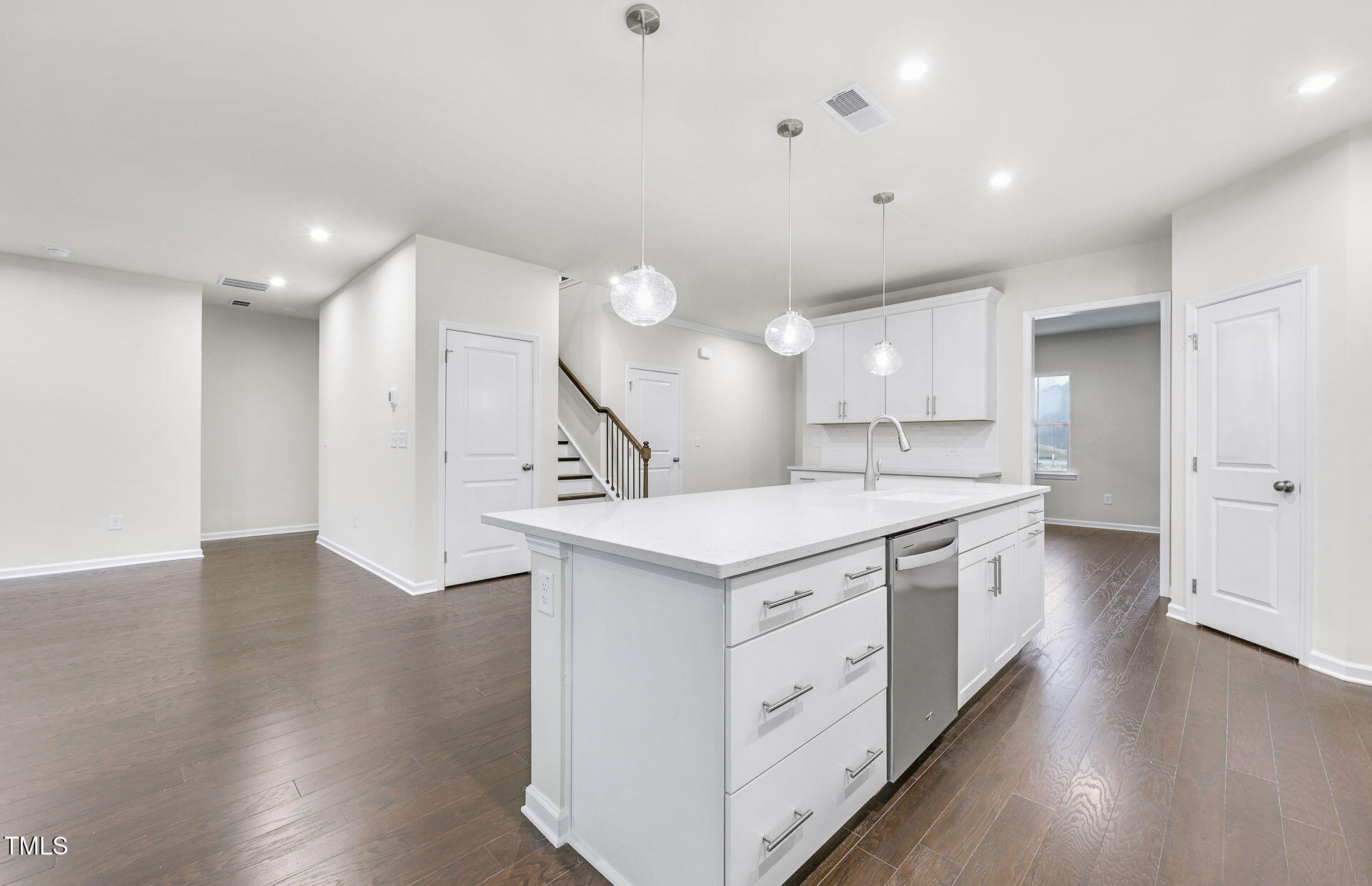 1103 Freestone Road Durham, NC 27703 - Photo 2 of 17 an open kitchen with a sink and wooden floor
