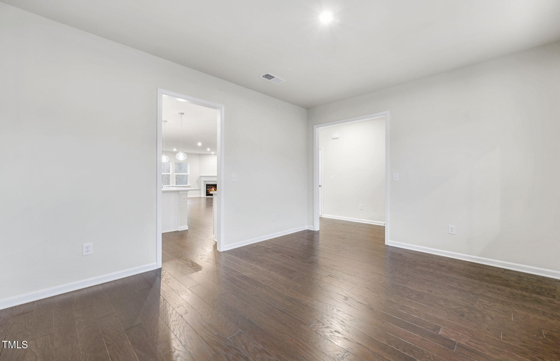 1103 Freestone Road Durham, NC 27703 - Photo 7 of 17 a view of a big room with wooden floor and windows