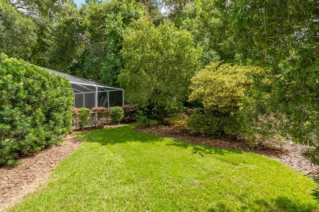 a view of a house with backyard and sitting area