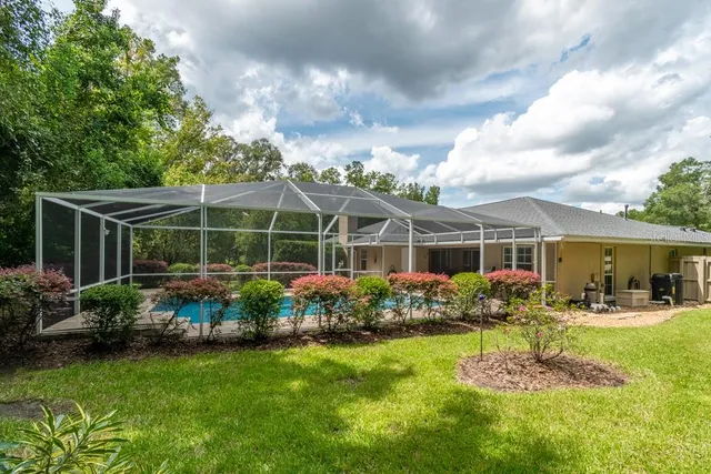 a garden with trees in the background