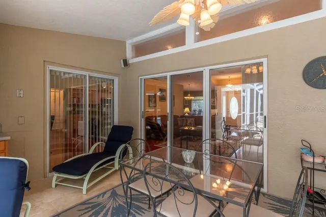 a view of a dining room with furniture and chandelier