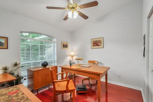 a bedroom with a bed chandelier and a window