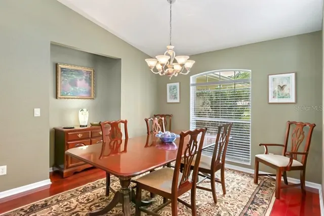 a view of a room with a table and chairs