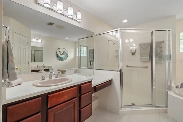 a kitchen with stainless steel appliances granite countertop a refrigerator a stove and a sink