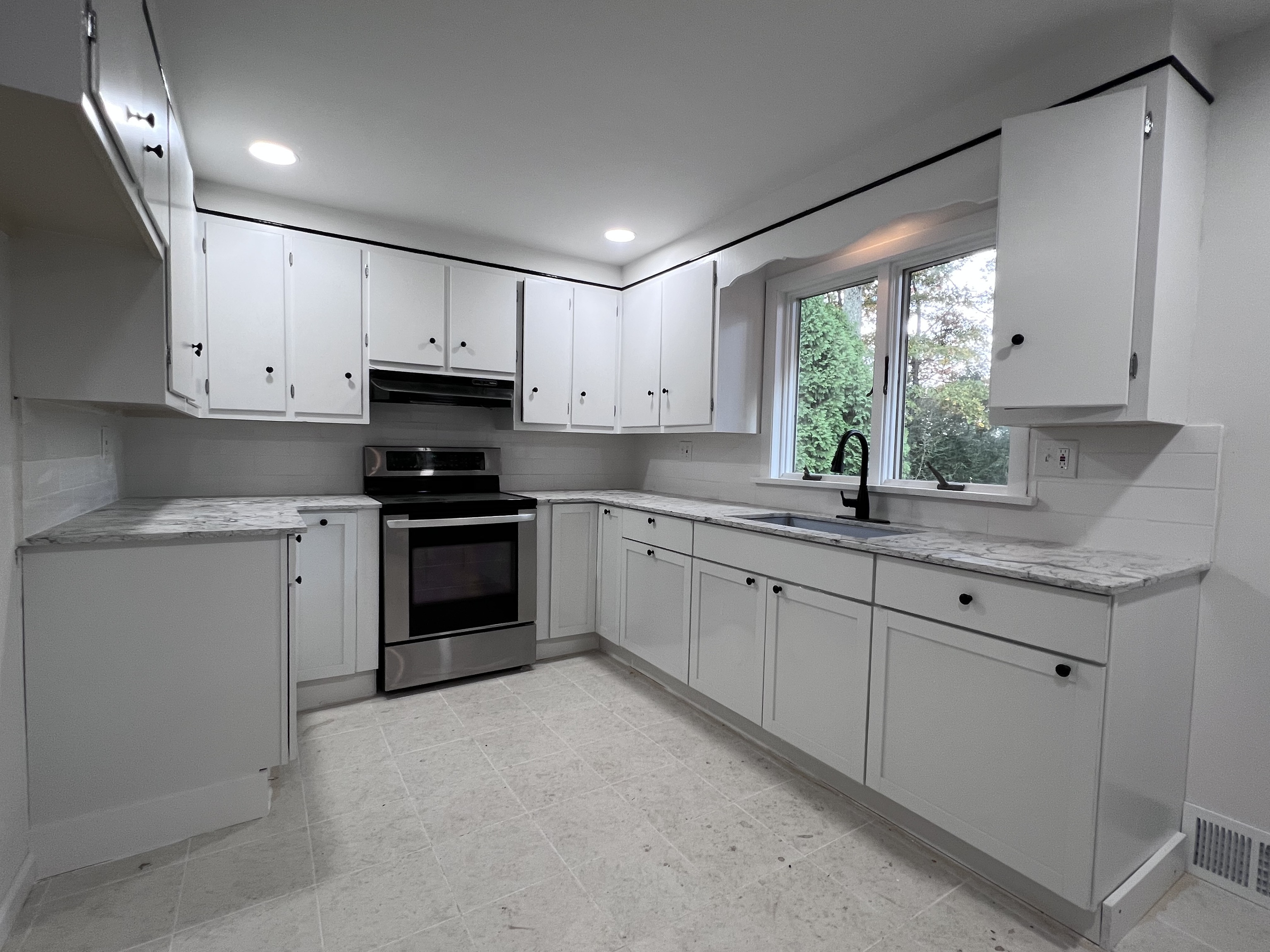 92 Birch Lane Naugatuck, CT 06770 - Photo 15 of 17 a kitchen with granite countertop white cabinets white appliances a sink and a window