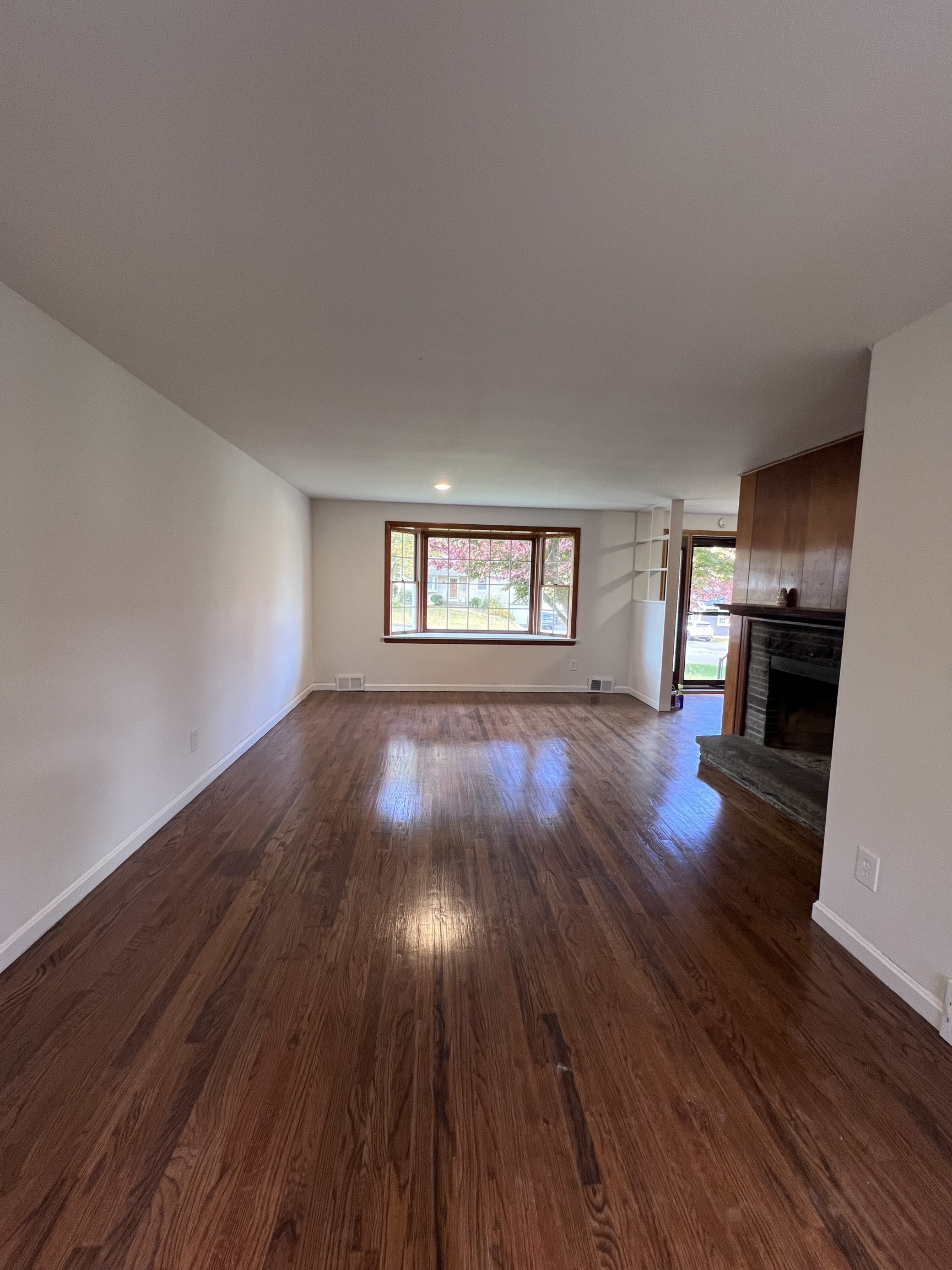 92 Birch Lane Naugatuck, CT 06770 - Photo 2 of 17 a view of empty room with wooden floor and fireplace