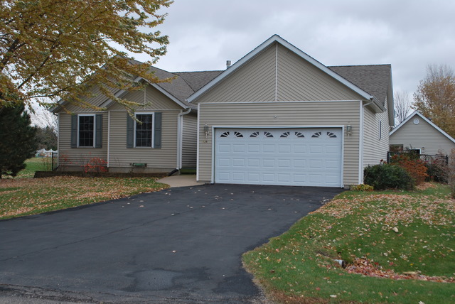 126 Windward Lane Rochelle, IL 61068 - Photo 1 of 25 a front view of a house with a yard and garage