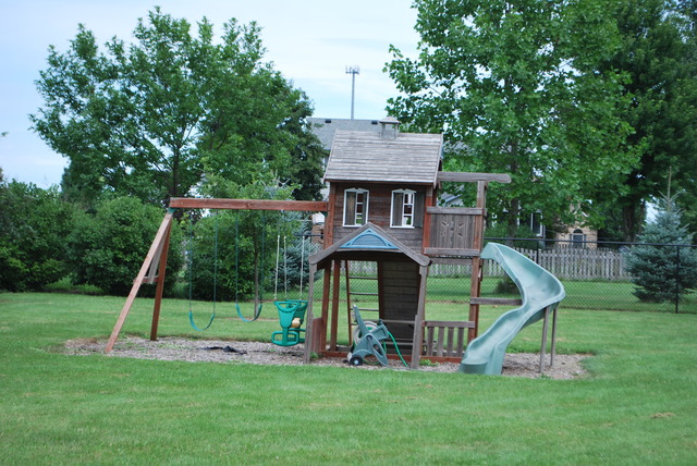 126 Windward Lane Rochelle, IL 61068 - Photo 20 of 25 a view of a house with a backyard and a tree