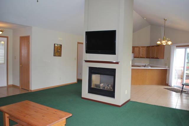 126 Windward Lane Rochelle, IL 61068 - Photo 3 of 25 a living room with furniture a flat screen tv and a fireplace