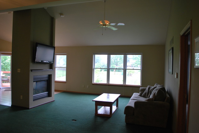 126 Windward Lane Rochelle, IL 61068 - Photo 4 of 25 a living room with furniture and a flat screen tv