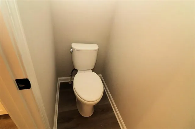 an empty room with a ceiling fan and a window