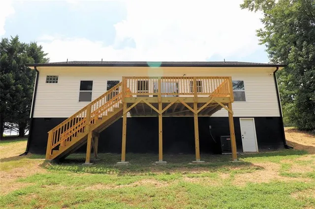 a view of a house with a backyard patio and deck