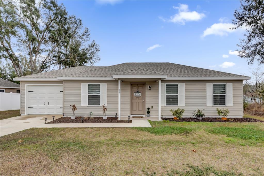 10 Pine Course Pass Ocala, FL 34472 - Photo 1 of 1 a front view of house with yard outdoor seating and barbeque oven