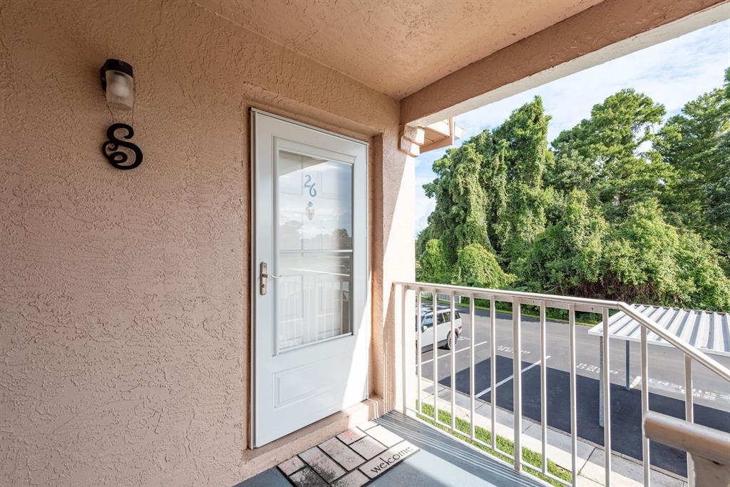 6410 Spring Flower Drive, Unit 26 New Port Richey, FL 34653 - Photo 12 of 38 a view of balcony with wooden floor