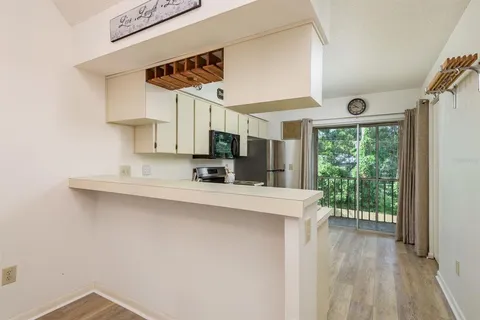 a kitchen with stainless steel appliances granite countertop a sink stove top oven and microwave