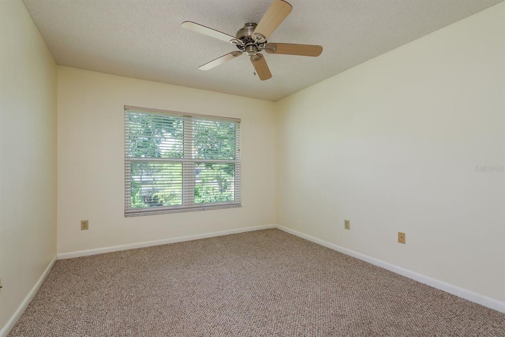 6410 Spring Flower Drive, Unit 26 New Port Richey, FL 34653 - Photo 19 of 38 an empty room with a window and a fan