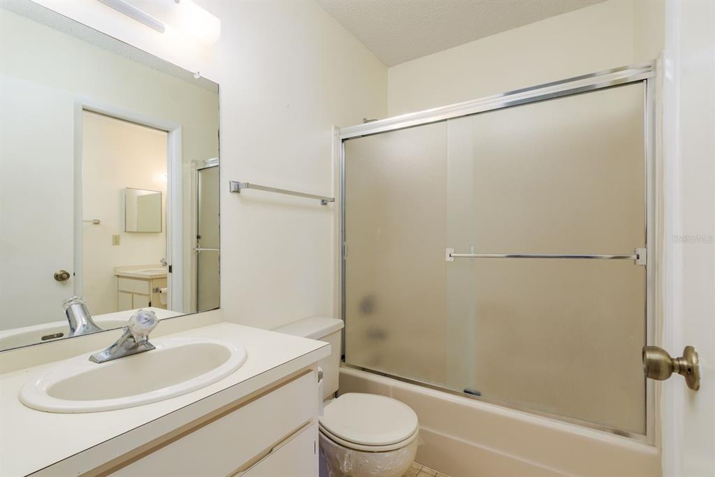 6410 Spring Flower Drive, Unit 26 New Port Richey, FL 34653 - Photo 21 of 38 a bathroom with a sink toilet and shower