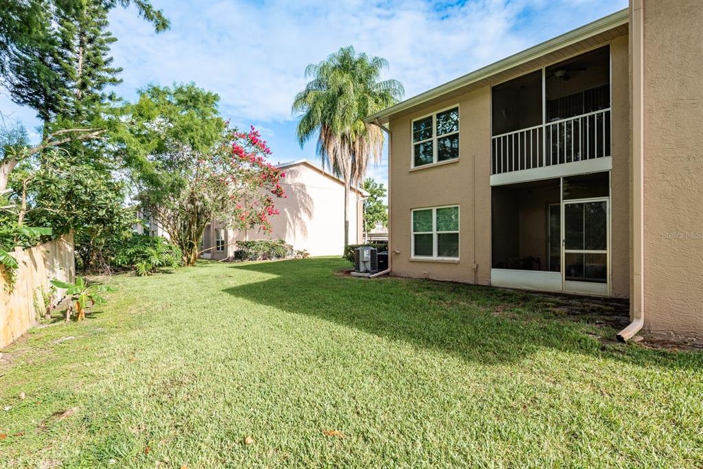 6410 Spring Flower Drive, Unit 26 New Port Richey, FL 34653 - Photo 28 of 38 a view of backyard of house with green space