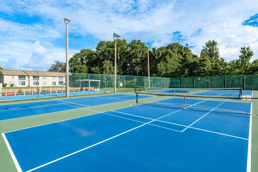 6410 Spring Flower Drive, Unit 26 New Port Richey, FL 34653 - Photo 30 of 38 a view of an outdoor space and tennis court