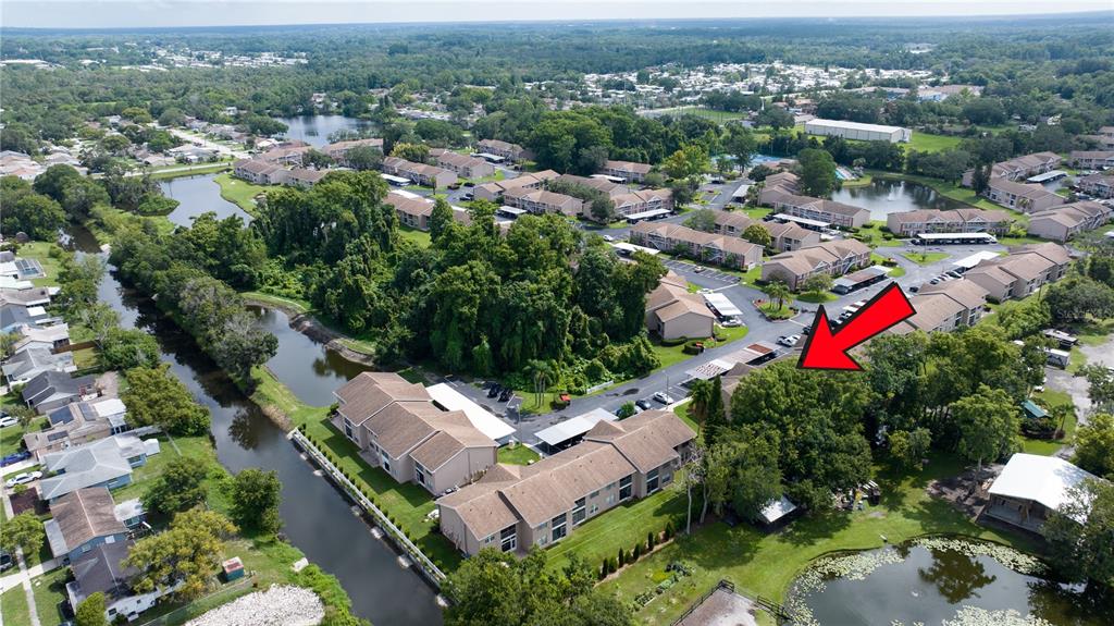 6410 Spring Flower Drive, Unit 26 New Port Richey, FL 34653 - Photo 36 of 38 an aerial view of residential house with outdoor space and trees