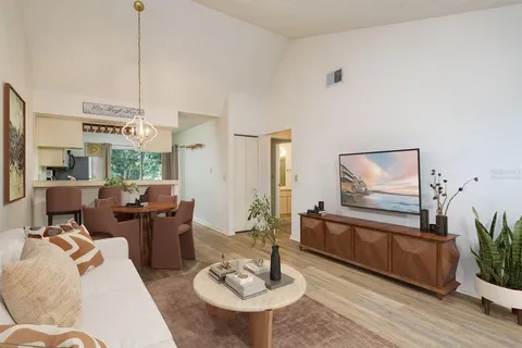 a living room with furniture and a wooden floor