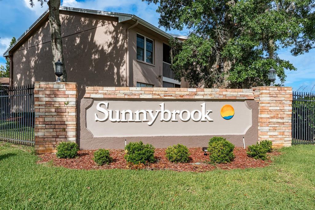 6410 Spring Flower Drive, Unit 26 New Port Richey, FL 34653 - Photo 9 of 38 a sign on the side of a building