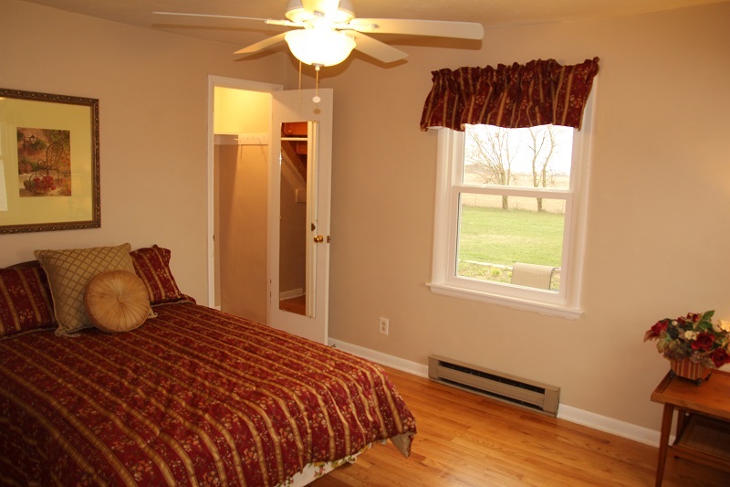 7685 Edson Road Capron, IL 61012 - Photo 11 of 23 a bedroom with a bed and wooden floor