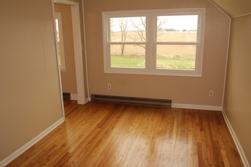 7685 Edson Road Capron, IL 61012 - Photo 16 of 23 an empty room with wooden floor and windows