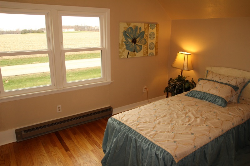 7685 Edson Road Capron, IL 61012 - Photo 18 of 23 a bed sitting in a bedroom next to a window