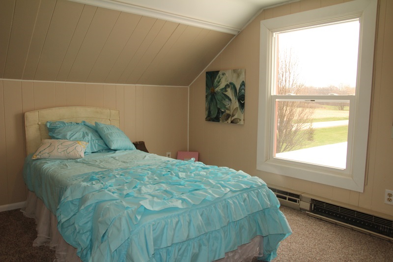 7685 Edson Road Capron, IL 61012 - Photo 19 of 23 a bed sitting in a bedroom next to a window