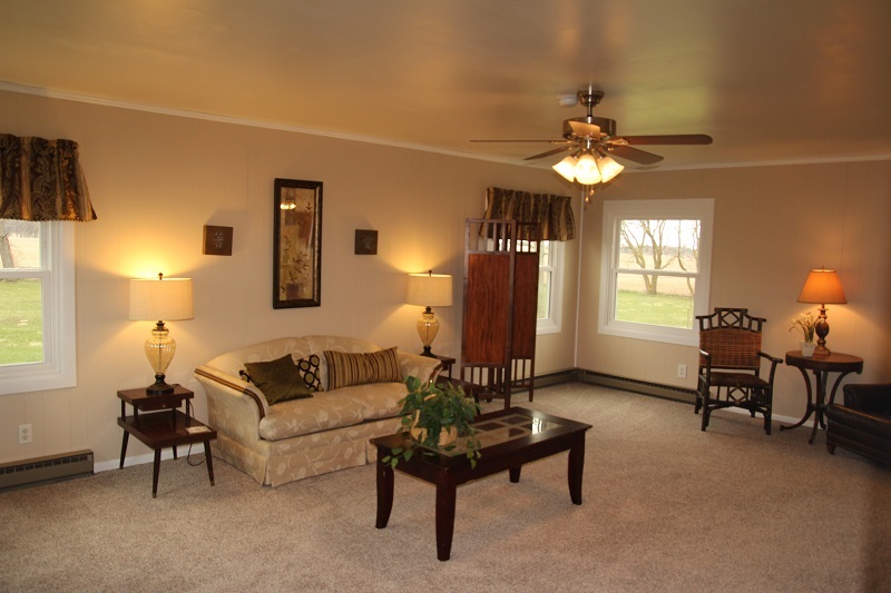 7685 Edson Road Capron, IL 61012 - Photo 8 of 23 a living room with furniture a chandelier and a window