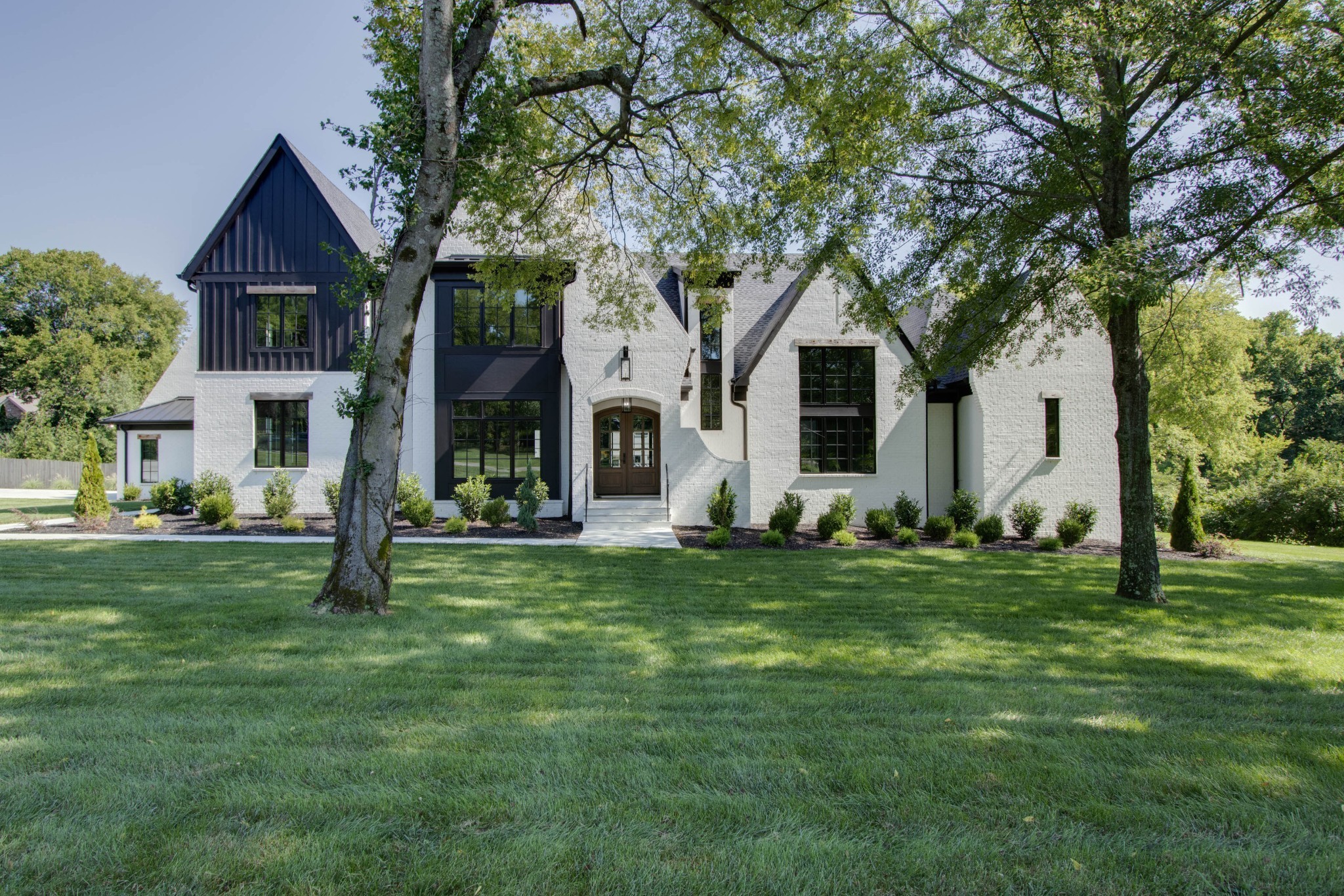 1300 Harding Place Nashville, TN 37215 - Photo 3 of 68 a front view of a house with a garden
