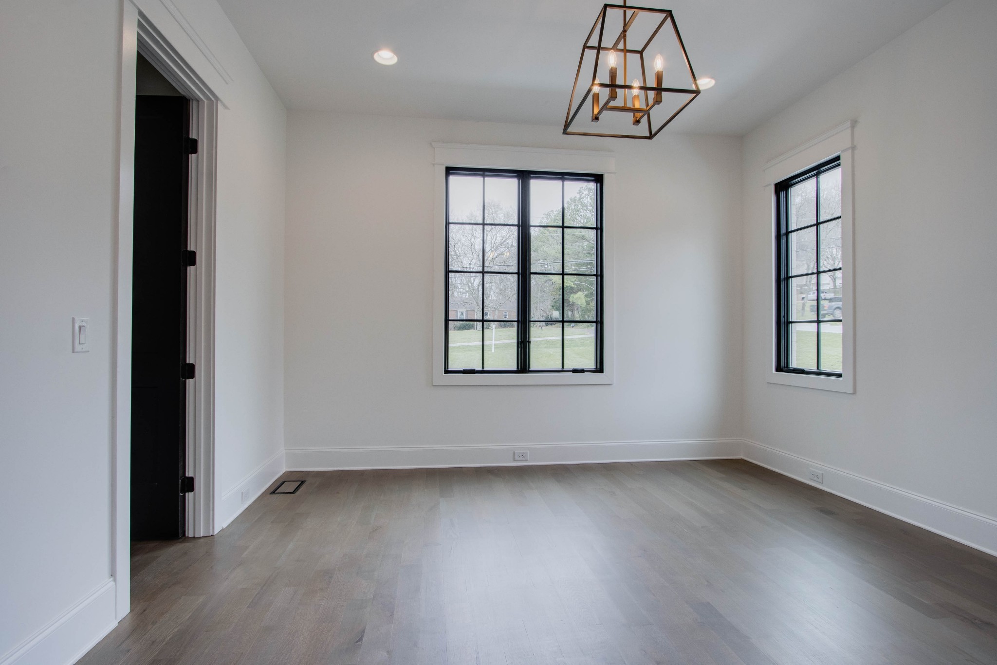 1300 Harding Place Nashville, TN 37215 - Photo 49 of 68 an empty room with wooden floor chandelier and windows