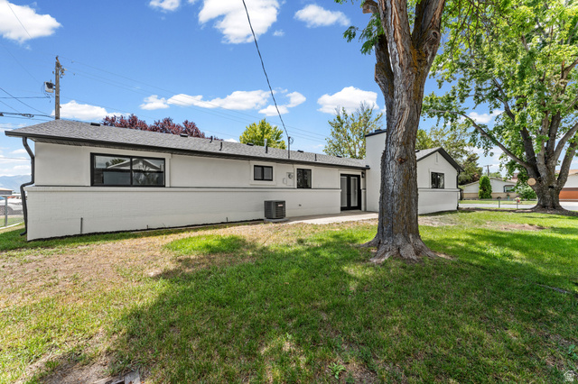 1898 West 600 South Provo, UT 84601 - Photo 31 of 32 Expansive backyard featuring a mature tree, a combination of established lawn and natural ground cover, and a concrete patio area