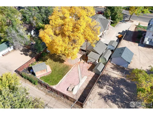 an aerial view of a house with a yard basket ball court and outdoor seating