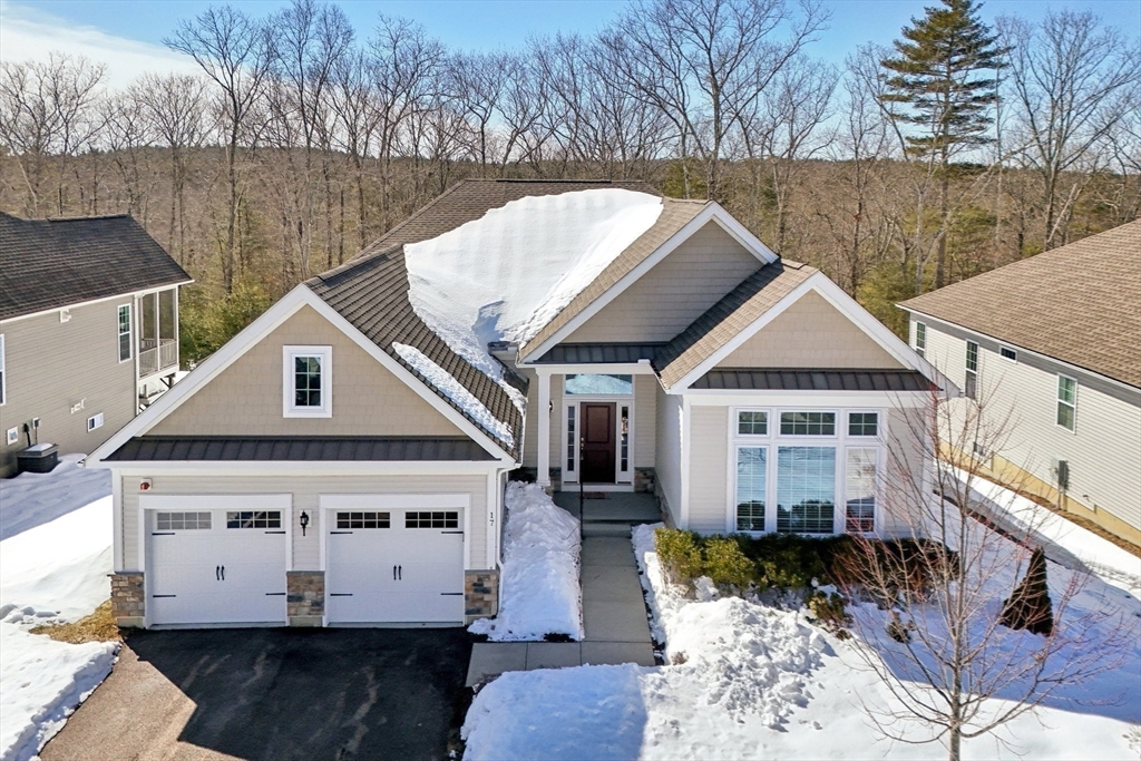 17 West View Lane, Unit 17 Stow, MA 01775 - Photo 16 of 32 a view of a white house with large trees and wooden fence