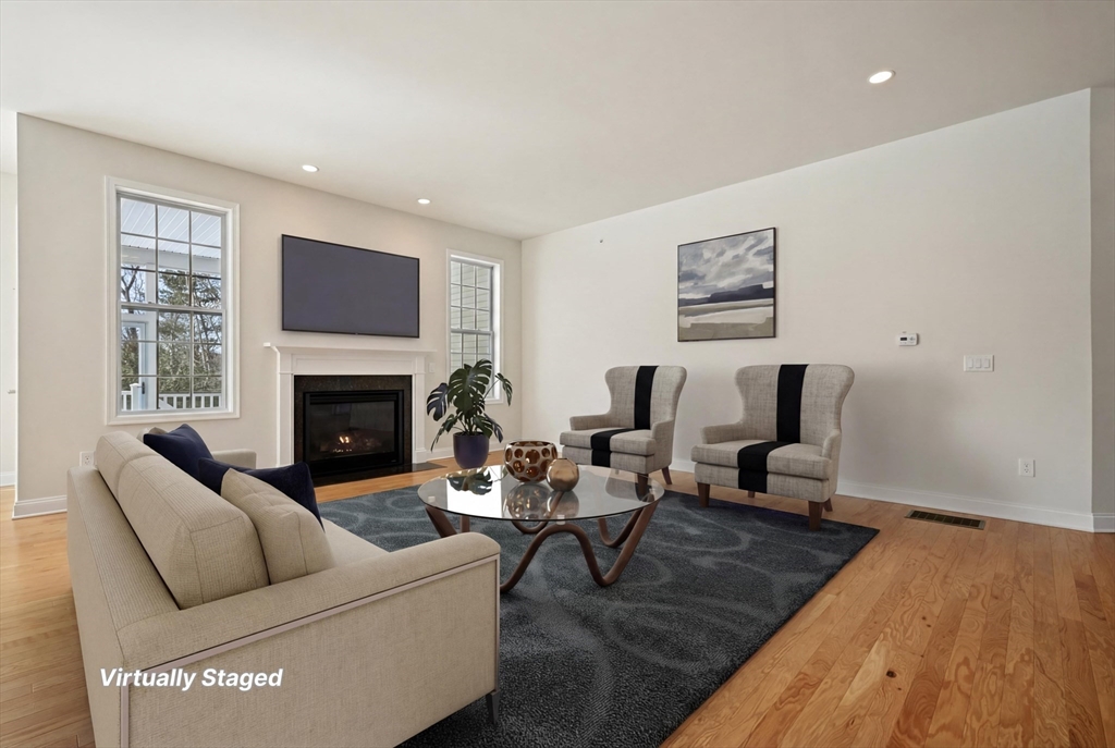 17 West View Lane, Unit 17 Stow, MA 01775 - Photo 2 of 32 a living room with furniture and a fireplace