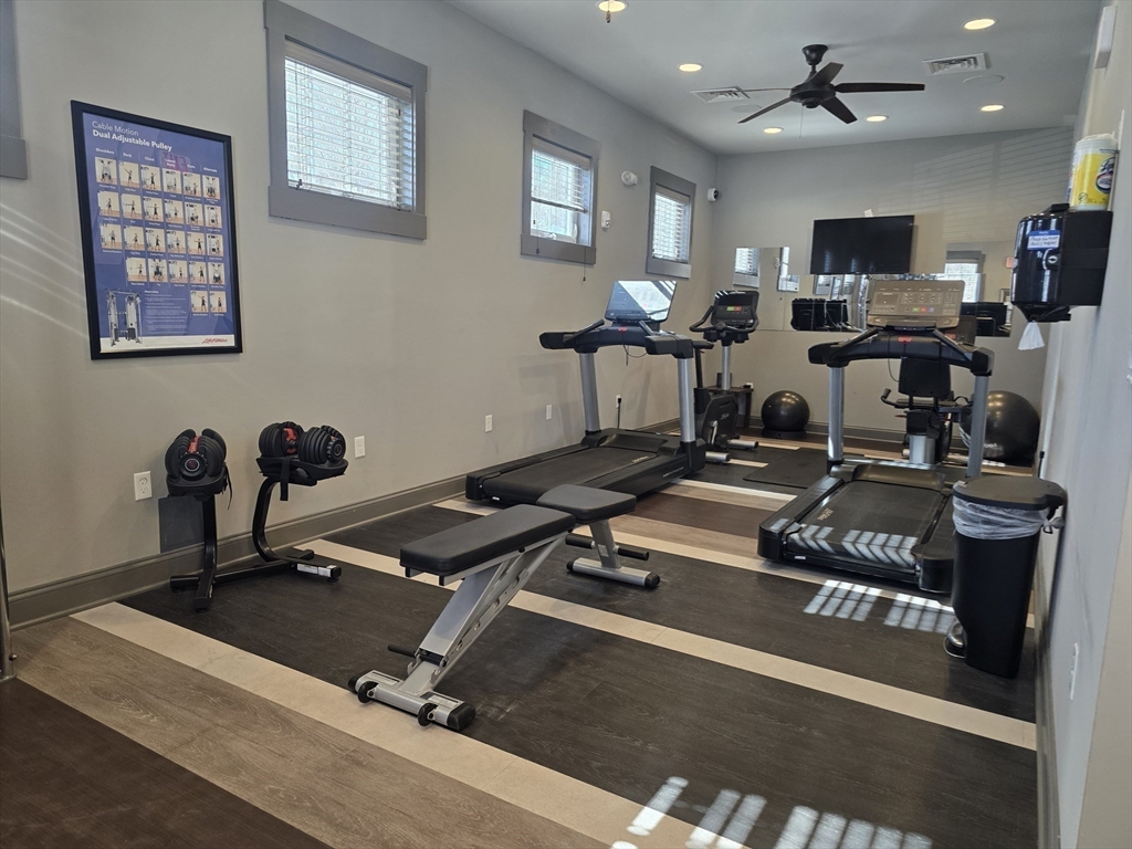 17 West View Lane, Unit 17 Stow, MA 01775 - Photo 31 of 32 a room with gym equipment and a flat screen tv