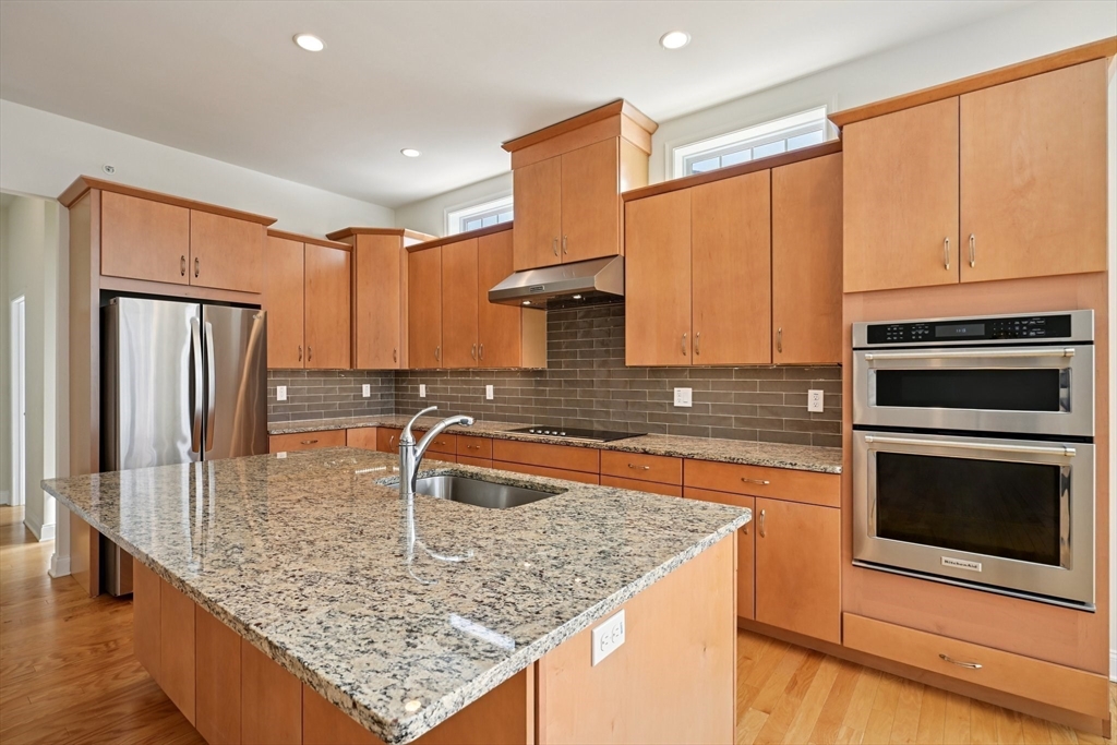 17 West View Lane, Unit 17 Stow, MA 01775 - Photo 4 of 32 a kitchen with stainless steel appliances granite countertop a sink a stove and a microwave