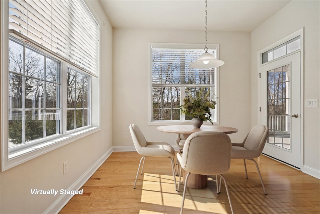 17 West View Lane, Unit 17 Stow, MA 01775 - Photo 5 of 32 a view of a dining room with furniture wooden floor and windows