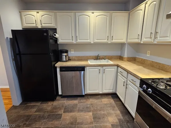 a kitchen with a sink and refrigerator