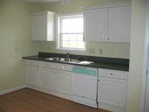 2903 New Salem Road Monroe, NC 28110 - Photo 4 of 8 a kitchen with granite countertop white cabinets and sink