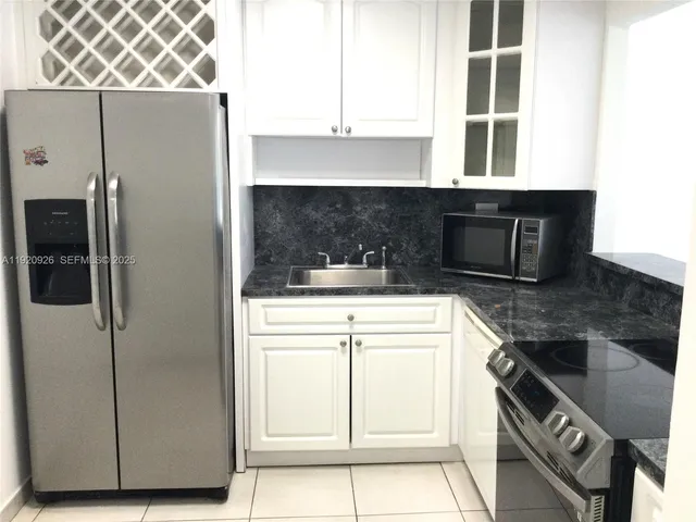 a kitchen with a refrigerator and a stove