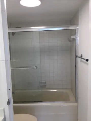 a bathroom with a sink a mirror and next to a window