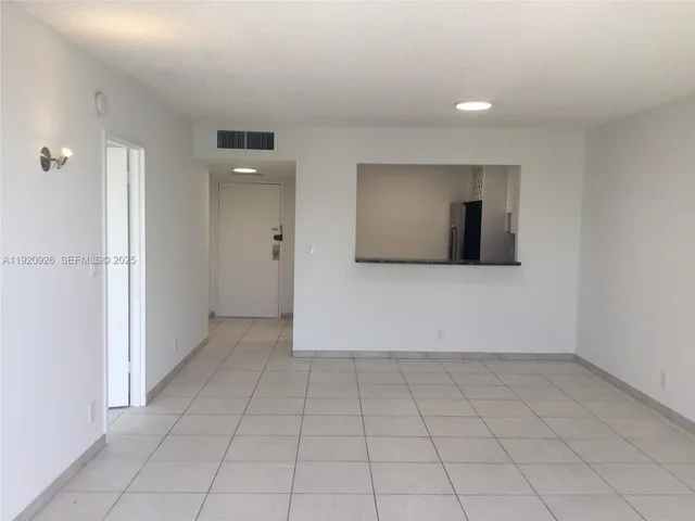 an empty room with closet and windows