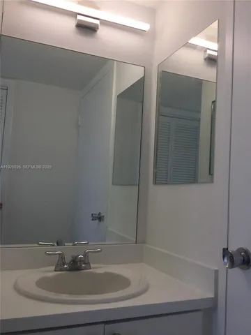 a bathroom with a mirror and a shower
